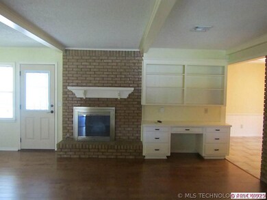 Family room with wood burning fireplace and built