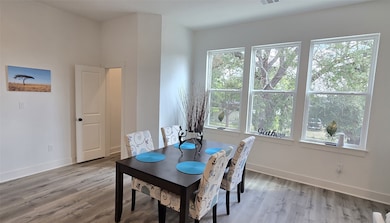 Enjoy dining in this room which overlooks a wide open space with mature oak trees.