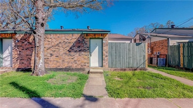 View of front of home featuring fence and brick si