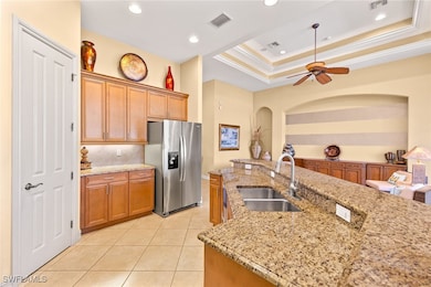 Kitchen featuring stainless steel fridge, a sink,