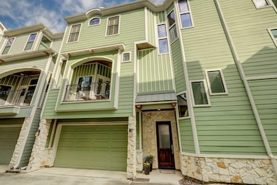 This photo shows a modern, three-story home with a
