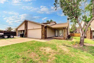 Ranch-style home featuring a garage and a front ya