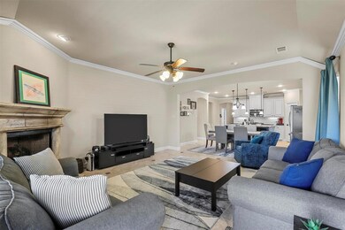 Living room featuring ceiling fan, light tile patt