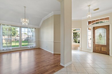 Elegant dining room with abundant natural light and rich wood floors, perfect for hosting memorable gatherings.