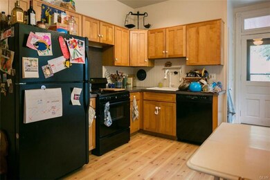 Modern kitchen with gas range and dishwasher.