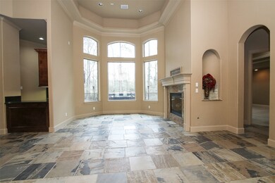 Welcome in to the large foyer! The formal loving room features a gas fireplace to set the tone while entertaining your guests. The rotunda ceiling with double crown molding is simply unique. The wall of windows over look the patio and hot tub area.