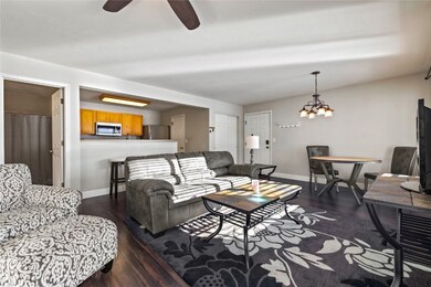 Living room featuring ceiling fan with notable cha