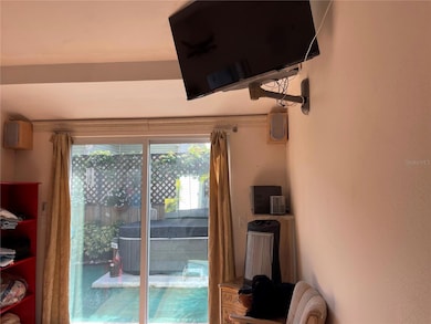 TV conveys with home. Sliding glass doors open out to private garden and spa