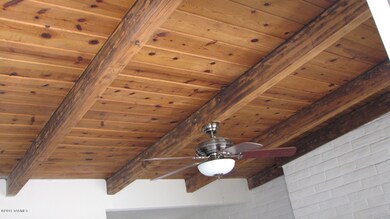 Wood and beamed ceiling with fan