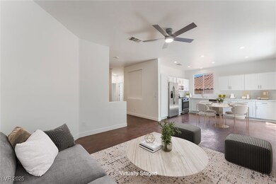 Living room featuring dark wood-style floors, ceil