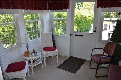 Enter through this lovely enclosed porch