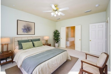 Spacious Primary bedroom suite offers ample room f