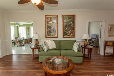 Living area with a ceiling fan, wood finished floo