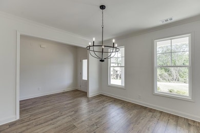 Unfurnished dining area with a chandelier, wood fi