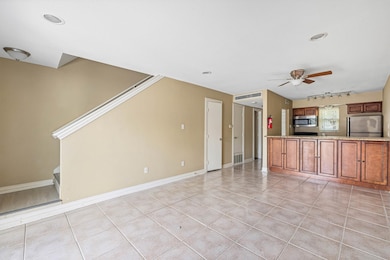 Open downstairs layout with great natural flow from living to kitchen, tile flooring throughout, and easy access to the private patio—comfortable and practical for everyday living.
