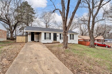 Single story home with a front lawn and a carport