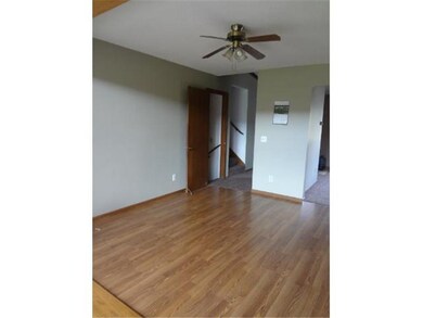 Dining area with laminate flooring. Dining flows t