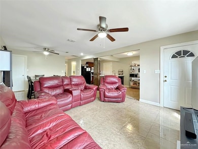 Living area featuring visible vents, baseboards, and ceiling fan