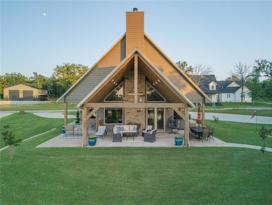 Rear view of house featuring an outdoor living space, a lawn, a chimney, and a patio
