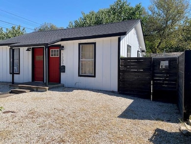 View of front of home with roof with shingles, a 