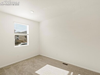 Carpeted empty room featuring baseboards