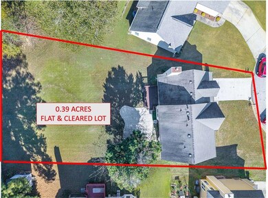 Aerial view of property and surrounding area featuring property boundaries highlighted