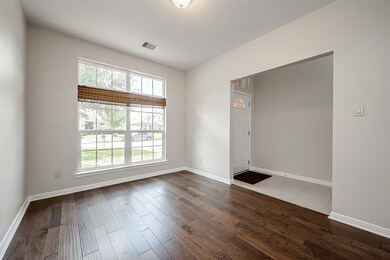 Bright and airy home office/study with large window, hardwood floors, and a view of the neighborhood.