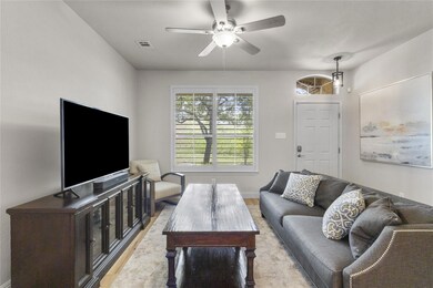 Living room with ceiling fan and wood finished fl