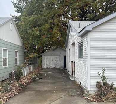 View of home's exterior with a garage, driveway, and an outbuilding