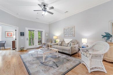 Living area featuring ceiling fan, ornamental mold