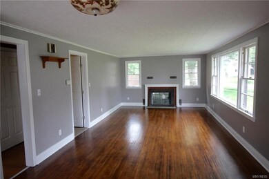 Living room has hardwood floors. lots of light, an