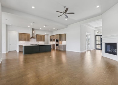 Unfurnished living room with dark wood-style floo