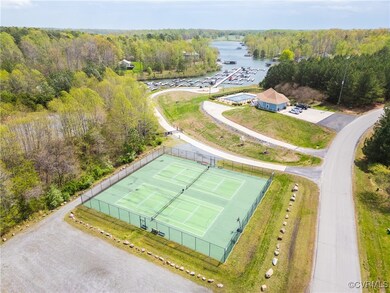 Bird's eye view of tennis, pool, and boat dock