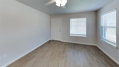 Unfurnished room featuring light wood-type flooring and ceiling fan