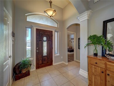 The welcoming entry features elevated ceilings, an