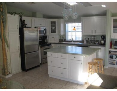 Living Room. Large custom windows & neutral tiled