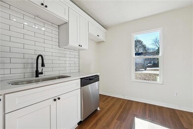 Kitchen with a sink, decorative backsplash, dishwa