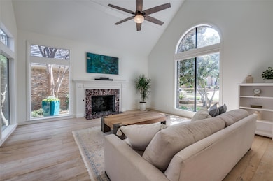 Living room with ceiling fan, high vaulted ceiling