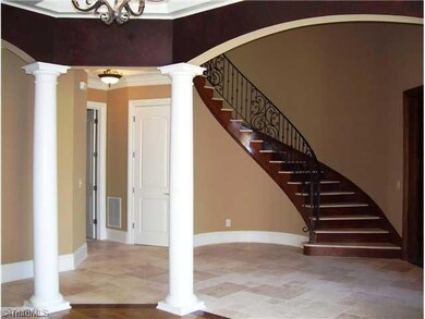 Entry. Columns define the formal dining room with curves, faux painting and coffered ceiling. Not shown is the mahogany parlour complete with hardwood floors and fireplace.