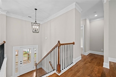 Foyer entrance featuring an inviting chandelier, c