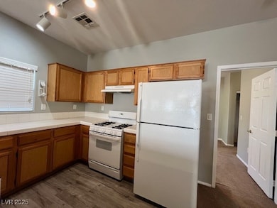 Kitchen with white appliances, under cabinet range