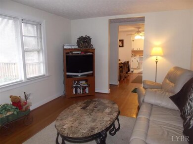 This view is from the living room towards the entrance foyer, dining room, and kitchen.