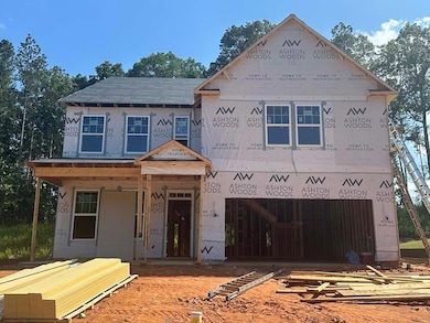Unfinished property featuring an attached garage and a porch