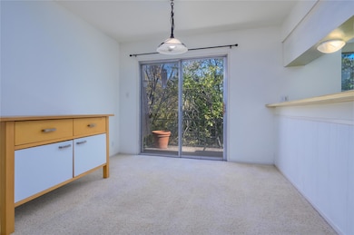 Unfurnished dining area with light carpet and bas