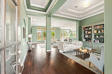 Guests enter the home to find rich wood tones and soothing paint colors witnessed from an impressive extended Foyer, drawing the eye inward toward views through the Great Room and beyond.
