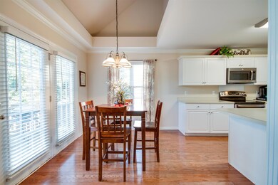 Living room leads into the eat-in dining area, and then into the kitchen.