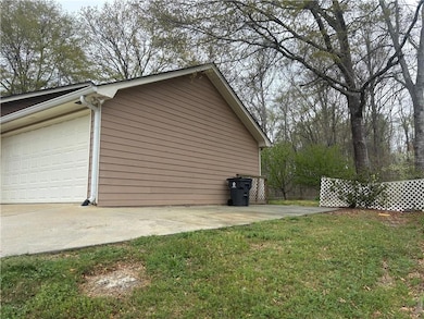 View of side of property featuring a yard and an a