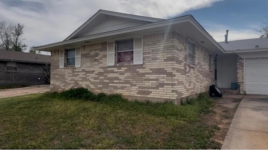 View of side of property featuring driveway, an at