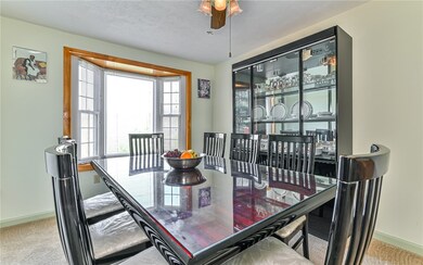 Light and bright dining room features bay window.