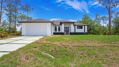 View of front facade with a front yard, driveway,